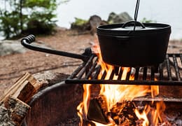 Iron Dutch oven in a fire. gives the feeling of an old fashioned campout