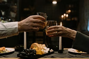 couple toasting over food.