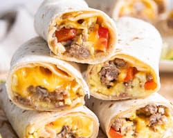 A pile of breakfast burritos.