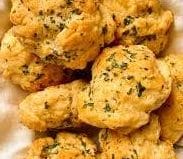 A plate full of yummy golden brown copycat Red Lobster Cheddar Bay biscuits
