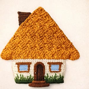 A very colorful crocheted potholder house.