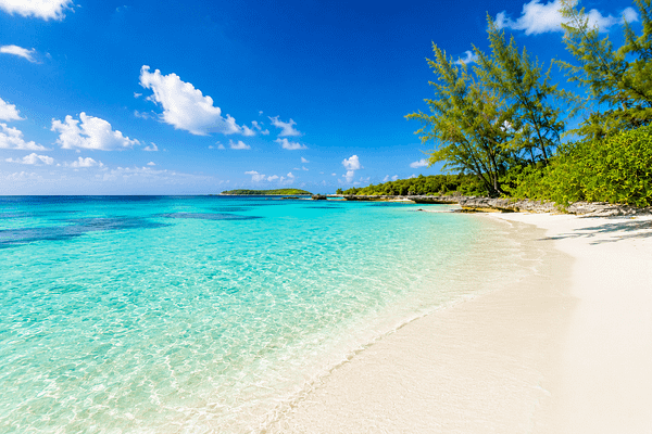 A beautiful sandy beach with a bight blue sky.
